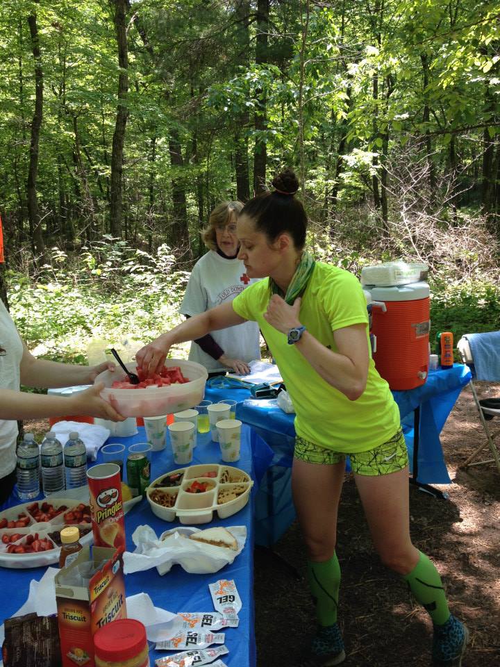 runner in yellow shirt grabs watermelon at Crisman Hollow aid station