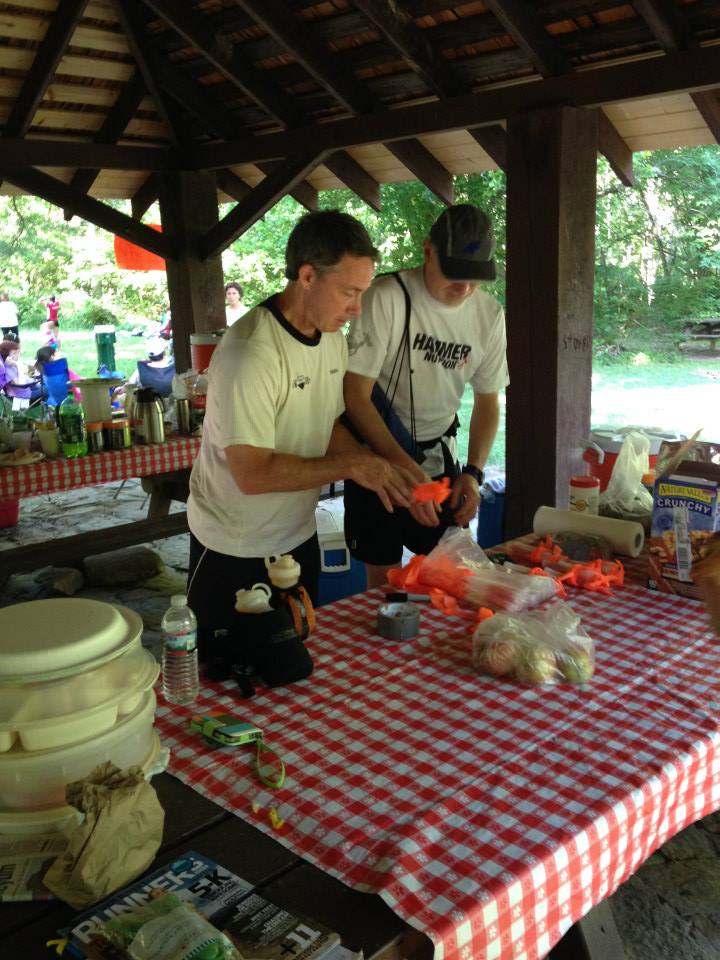 2 men pack a bag full of chem lights. 