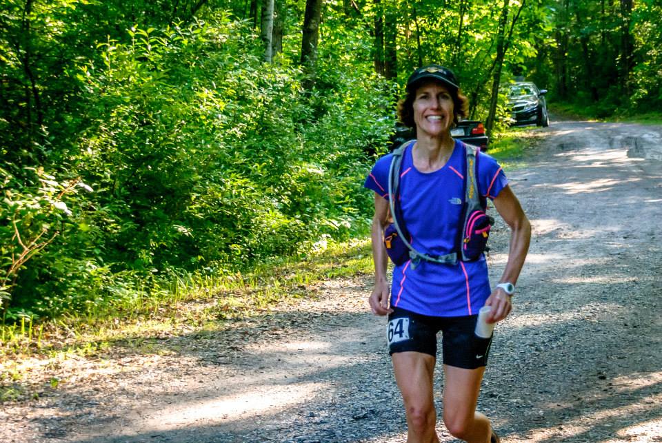 female runner smiles at camera