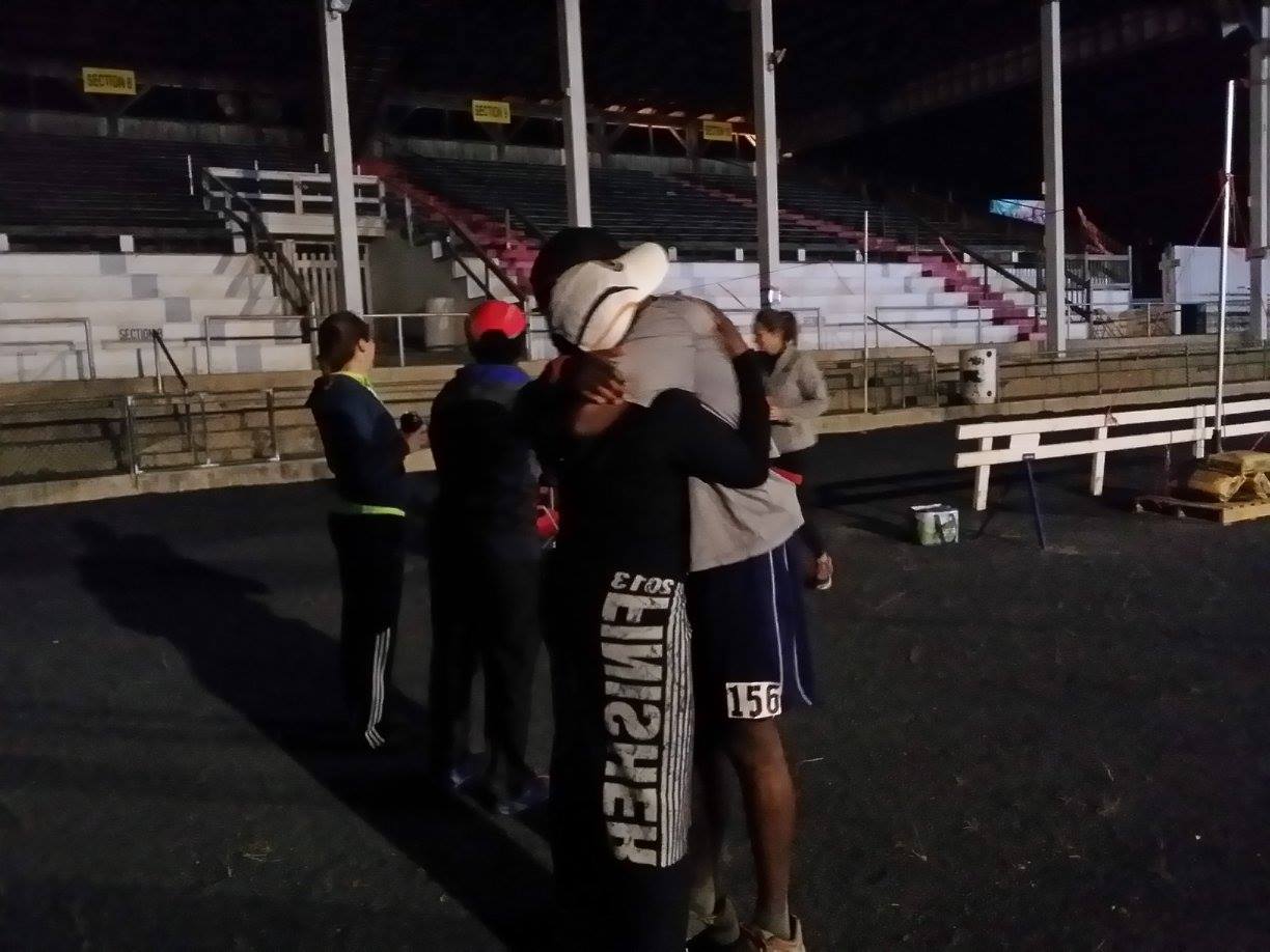 Bib 156, finishes and gives hug to his crew.