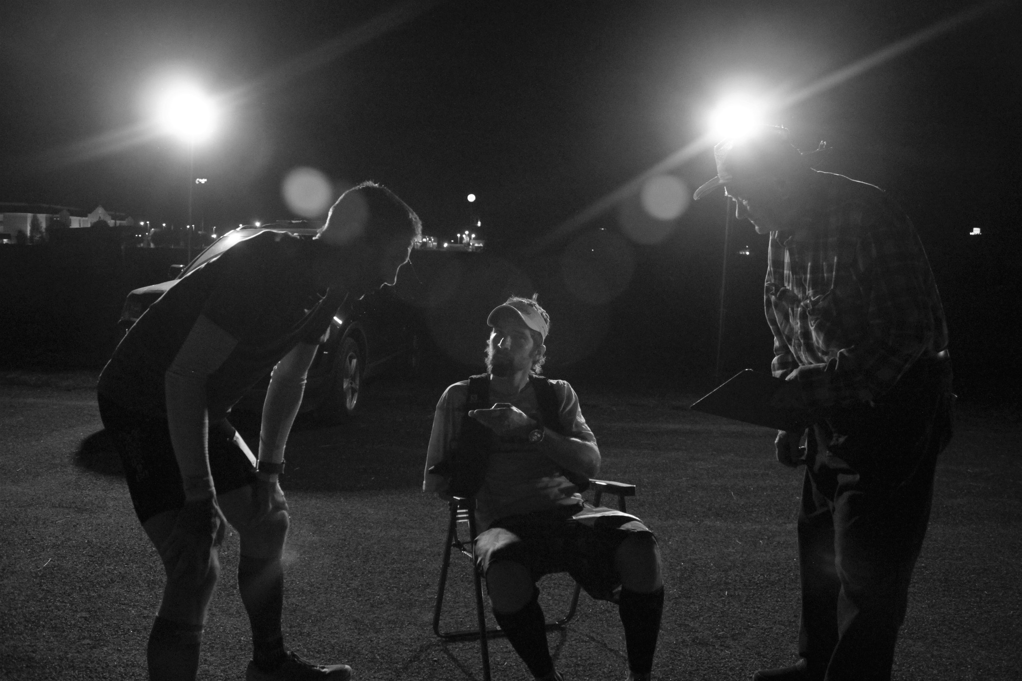 Black and white photo at the finish line of Chad Lasater, 
          James Weaver, and Henry, timer.