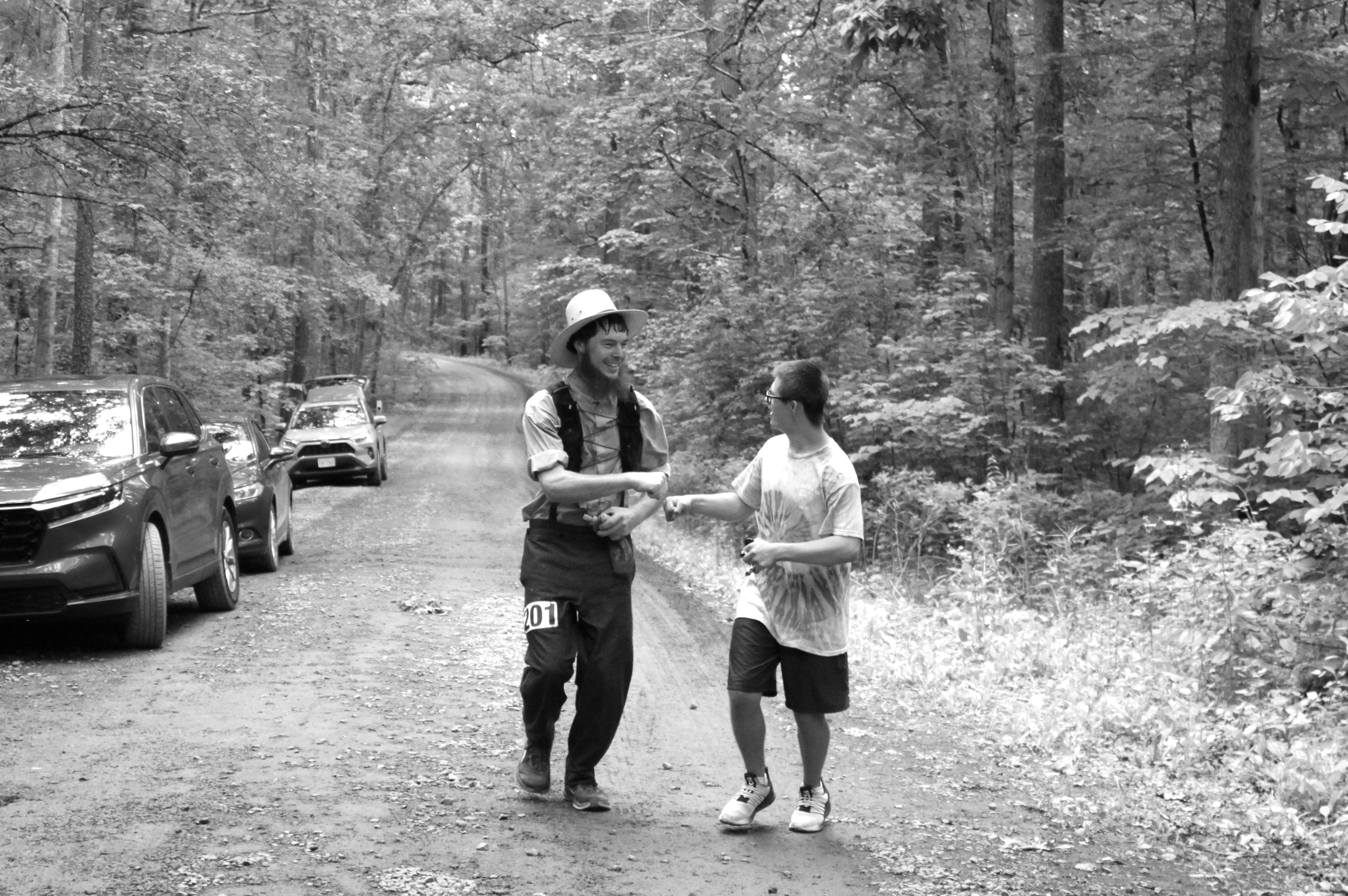 Runner fist bumps a 
            spectator while running.