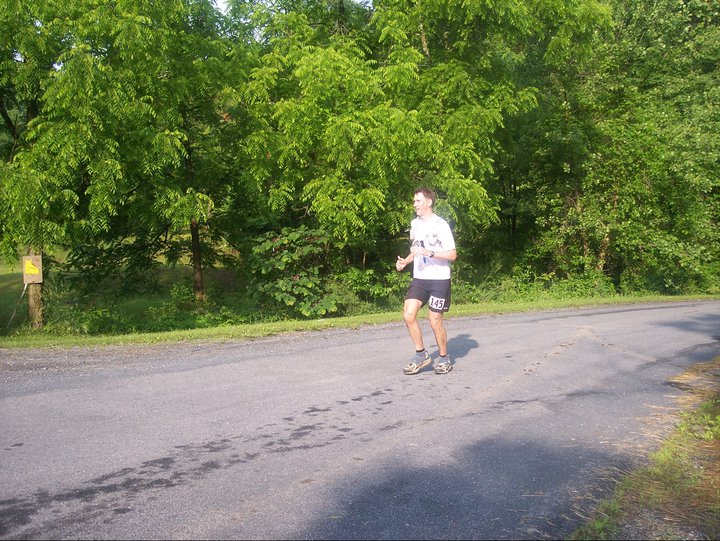 Runner with bib 145 running on a road